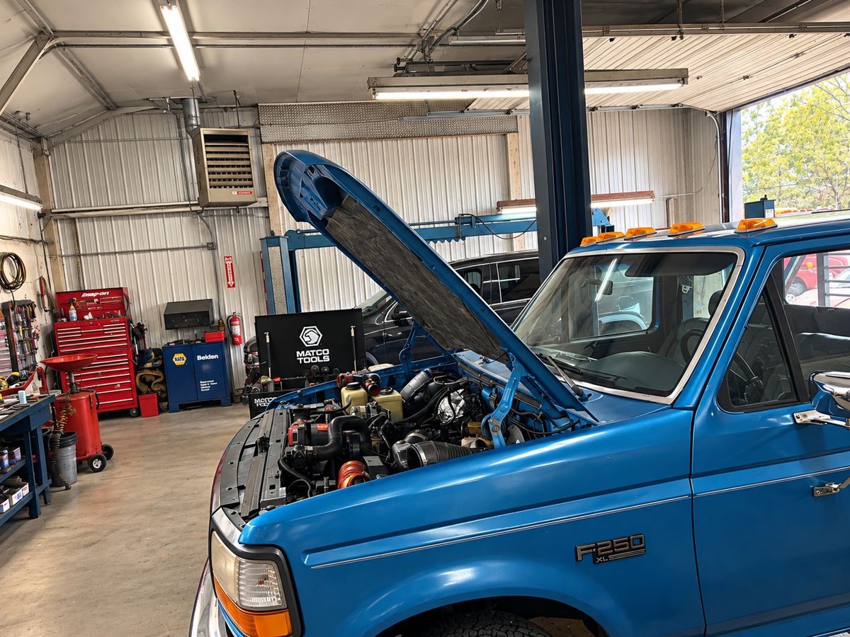 A blue Ford F-250 in the service bay